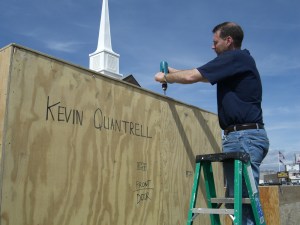 In the church parking lot Kevin screwing the door closed